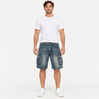 Model standing in a full front studio shot wearing Fleecora men's mid-waist regular-fit blue cargo denim shorts
