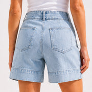 Back view of women’s light wash denim shorts with patch pockets