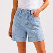 Close up of high waist denim shorts with statement pocket detail